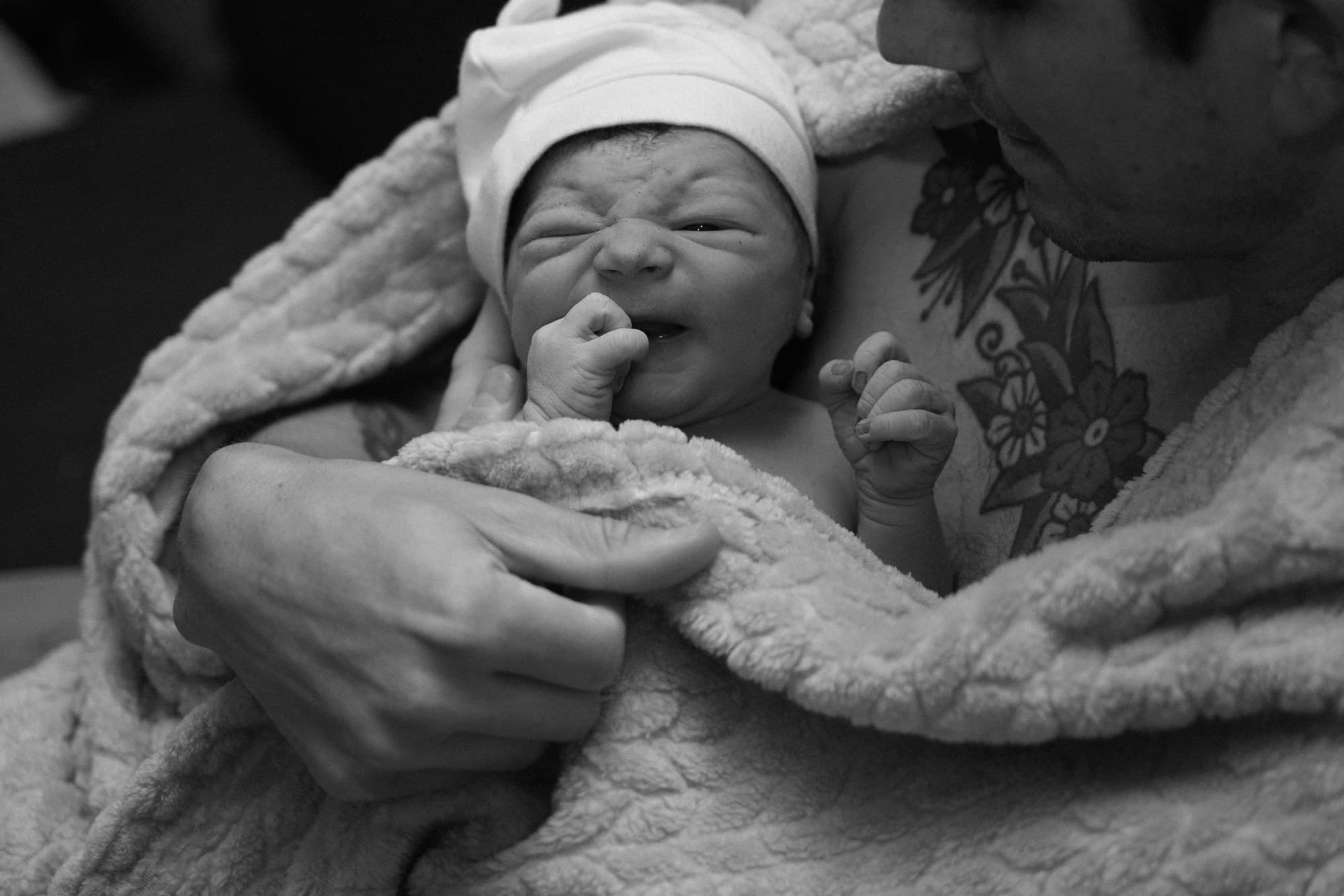 A father cradling his newborn at Transitions Birth Center