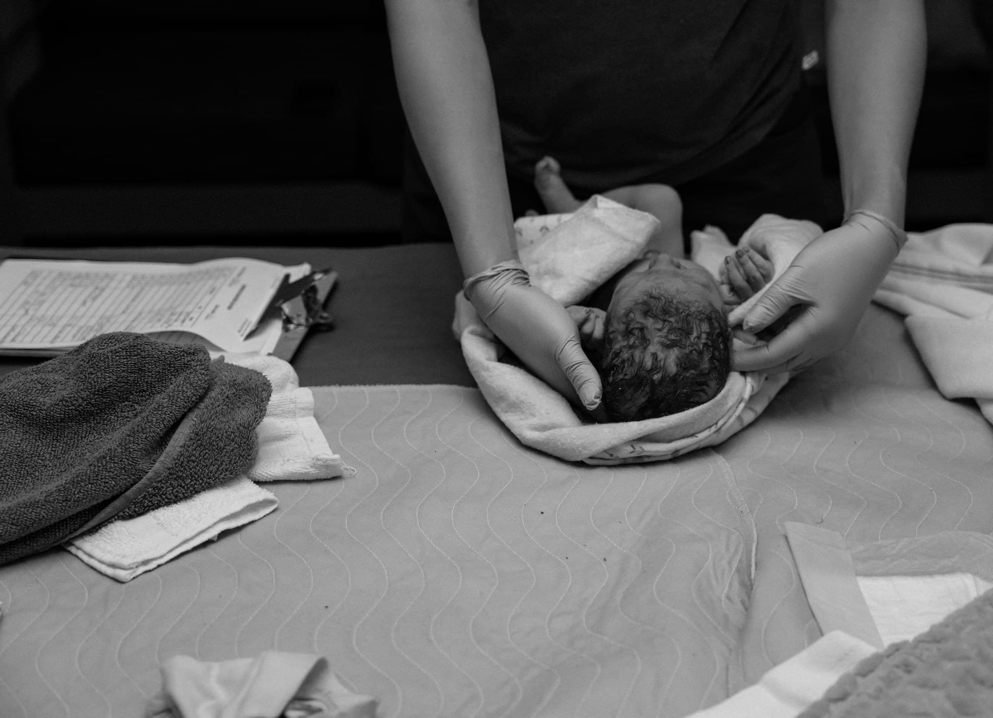 A midwife welcoming a newborn at Transitions Birth Center